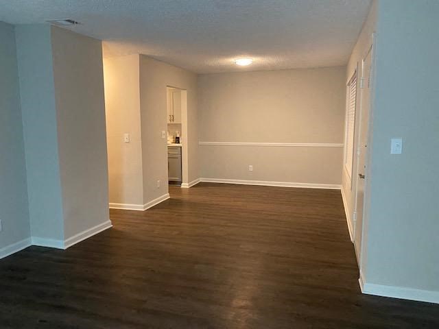Spacious living area with wood-style vinyl flooring and neutral walls at Wyndcliff Galleria, Smyrna, Georgia.
