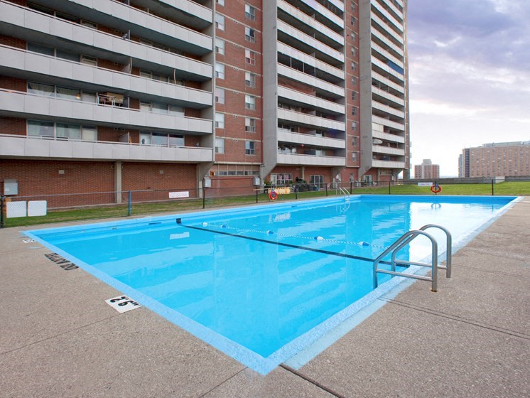 a swimming pool on the side of an apartment building