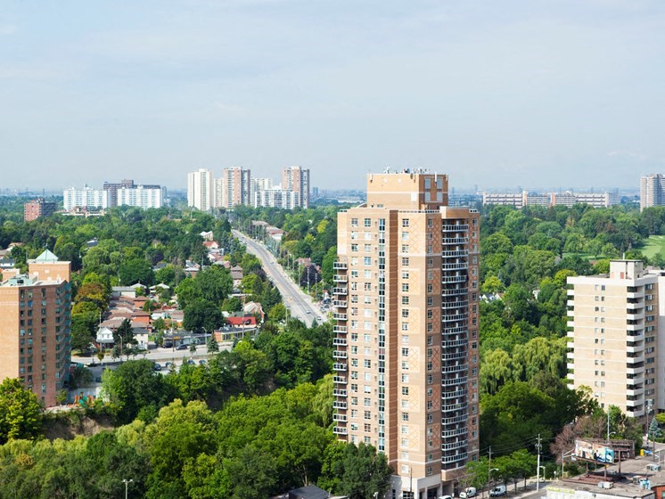 an aerial view of a city with tall buildings and trees