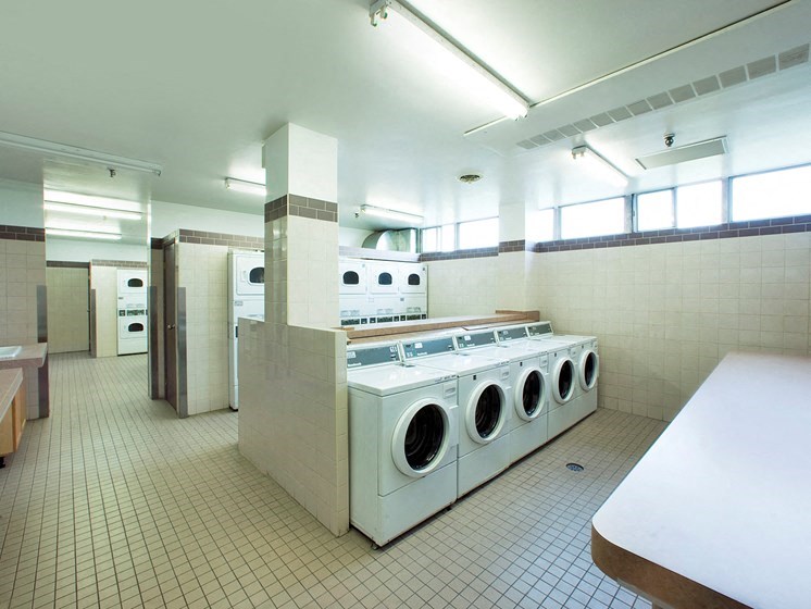 a laundry room with a bunch of washers and dryers