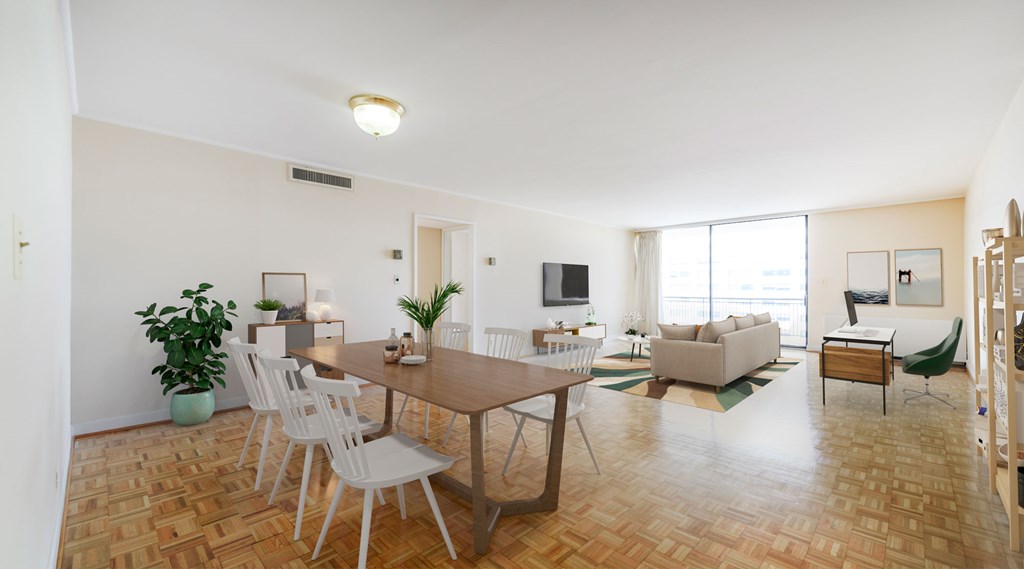 A living room with a brown table and white chairs.