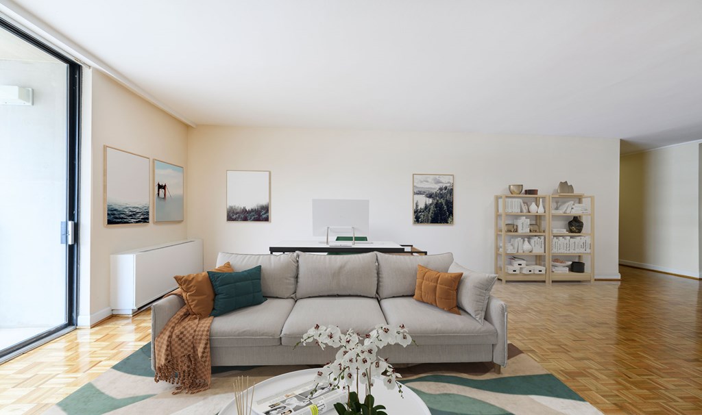 A living room with a grey couch and a white coffee table.