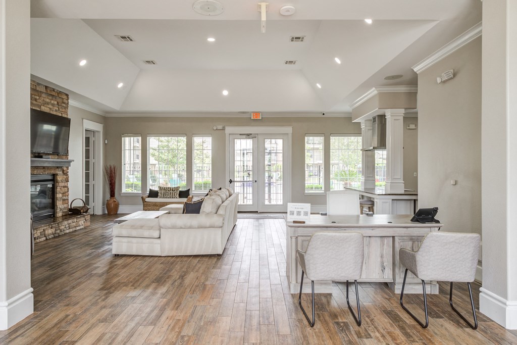 Club house with a tv and ceiling light and couches and chairs