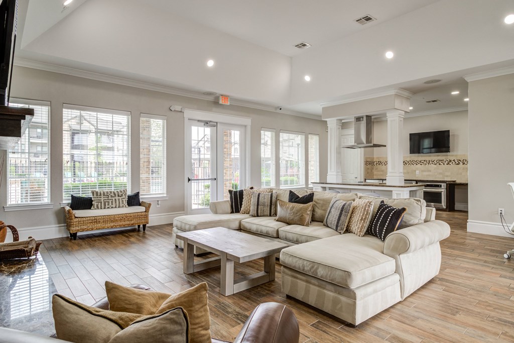 a clubhouse with a couch and a table and chairs and tv