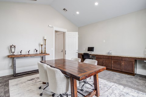 a conference room with a wooden table and chairs
