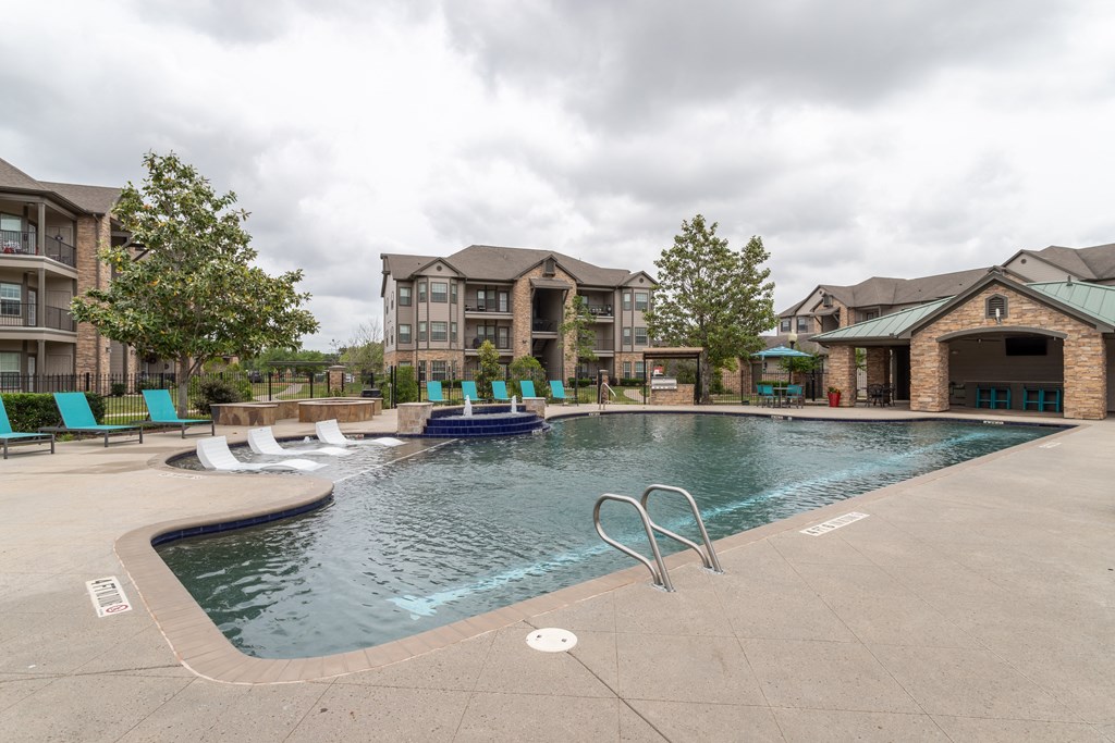 swimming pool surrounded by beach chairs