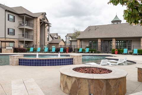 swimming pool surrounded by beach chairs and fire pit