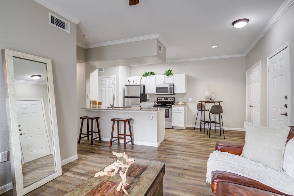 an open kitchen and living room with a couch and a table