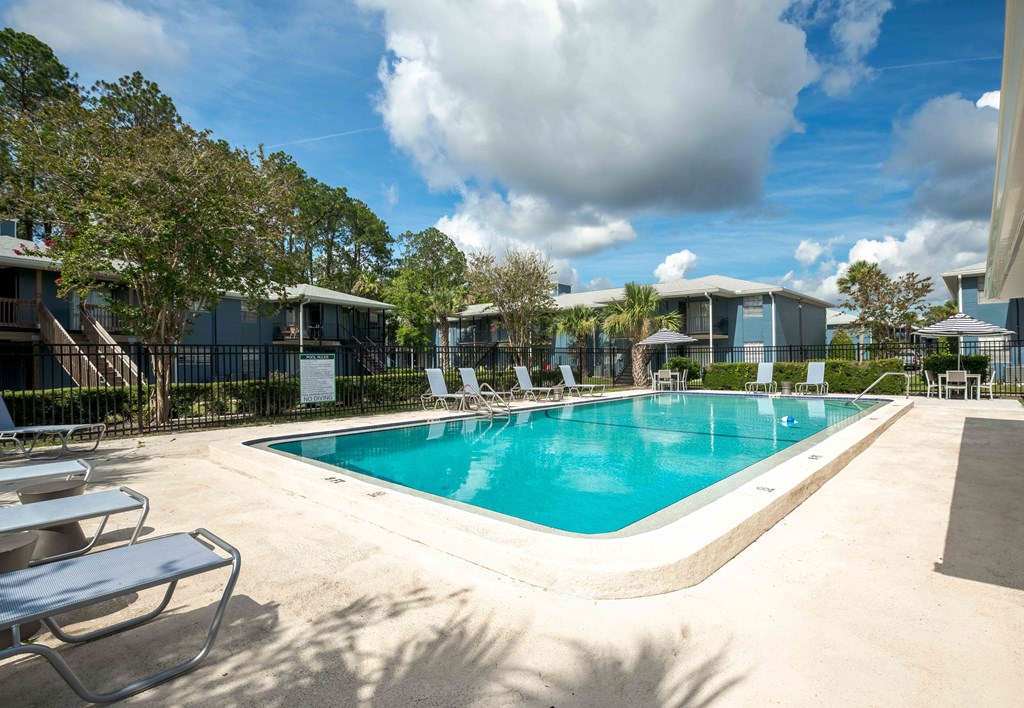 Swimming pool surrounded by lounge chairs at The Marley at Trout River in Jacksonville, Florida.