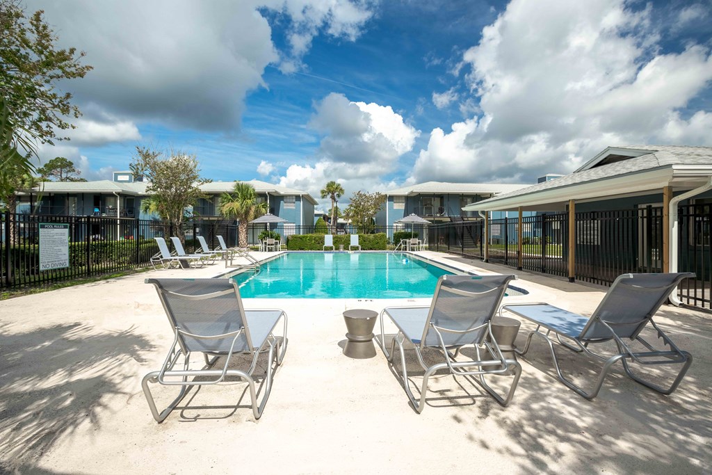 Swimming pool with lounge chairs at The Marley at Trout River in Jacksonville, Florida.