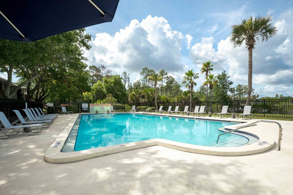 Resort-style pool area with seating at The Marley at Trout River in Jacksonville, Florida.