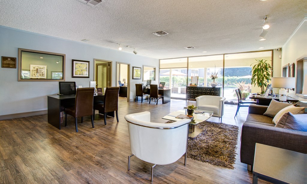 a living room and dining room with a view of the ocean