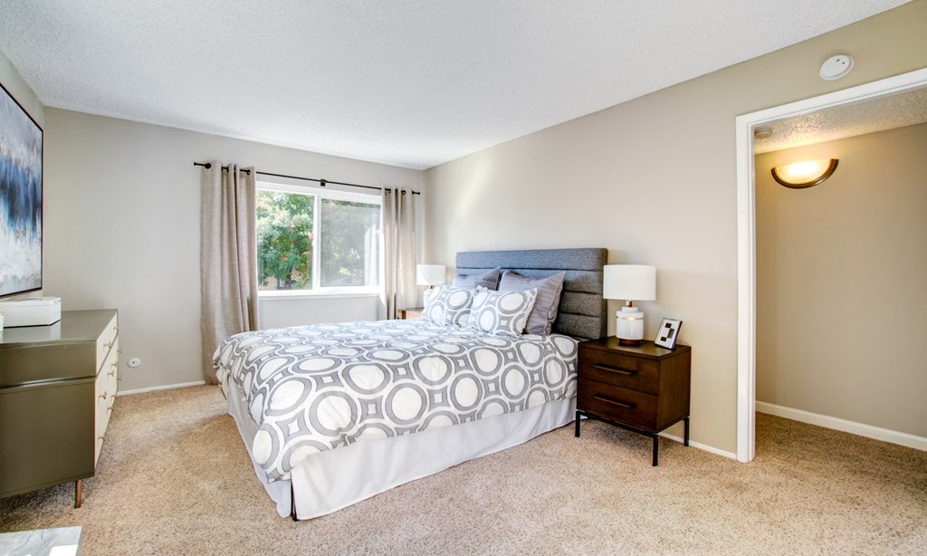 a bedroom with a bed and a window