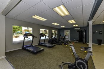 a room filled with lots of different types of exercise equipment
