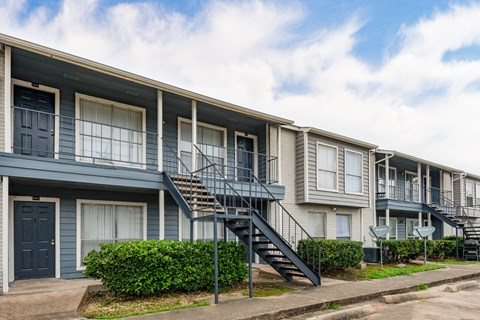 a row of apartment buildings with stairs and balconies
