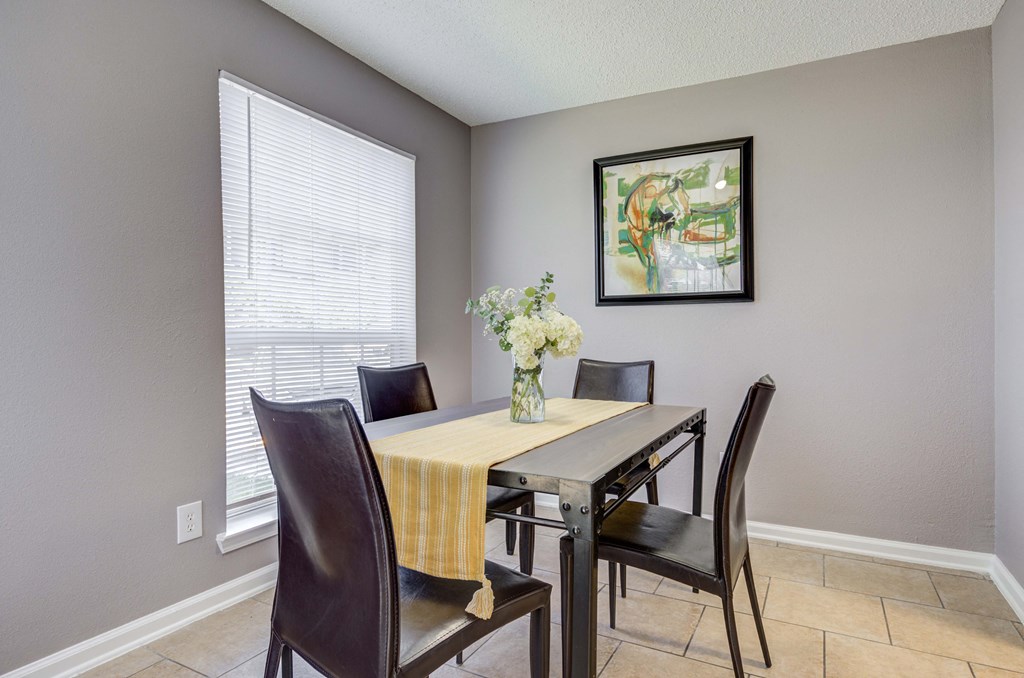Westchase Apartments in Harvey LA photo of a dining room with a table with chairs and a vase of flowers