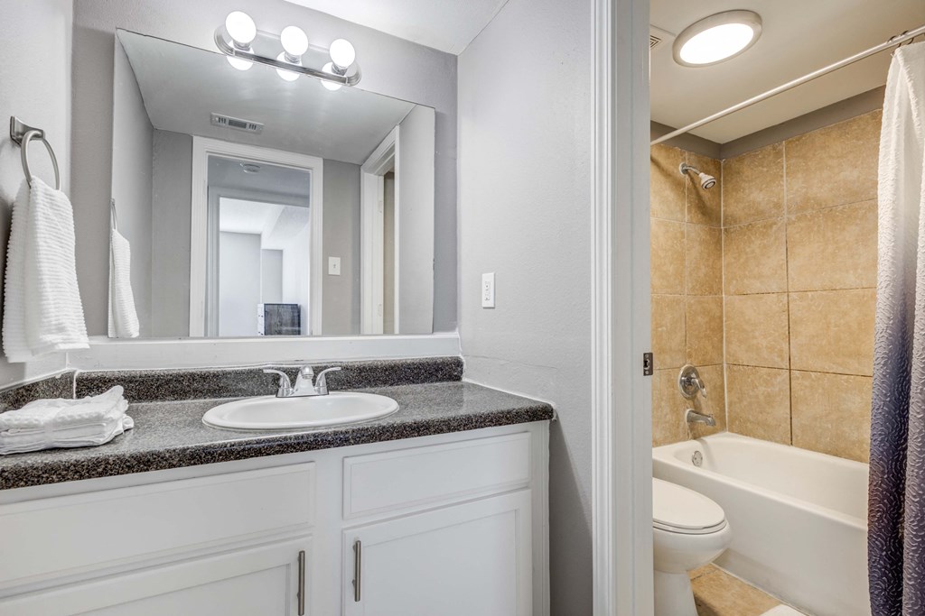 Westchase Apartments in Harvey LA photo of a bathroom with a sink and a toilet and a mirror