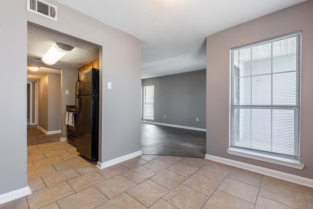 Westchase Apartments in Harvey LA photo of an empty living room with a large window and tile flooring