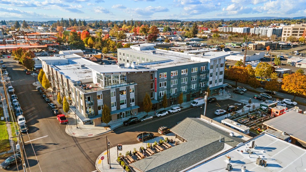 A large building with a parking lot in front of it.