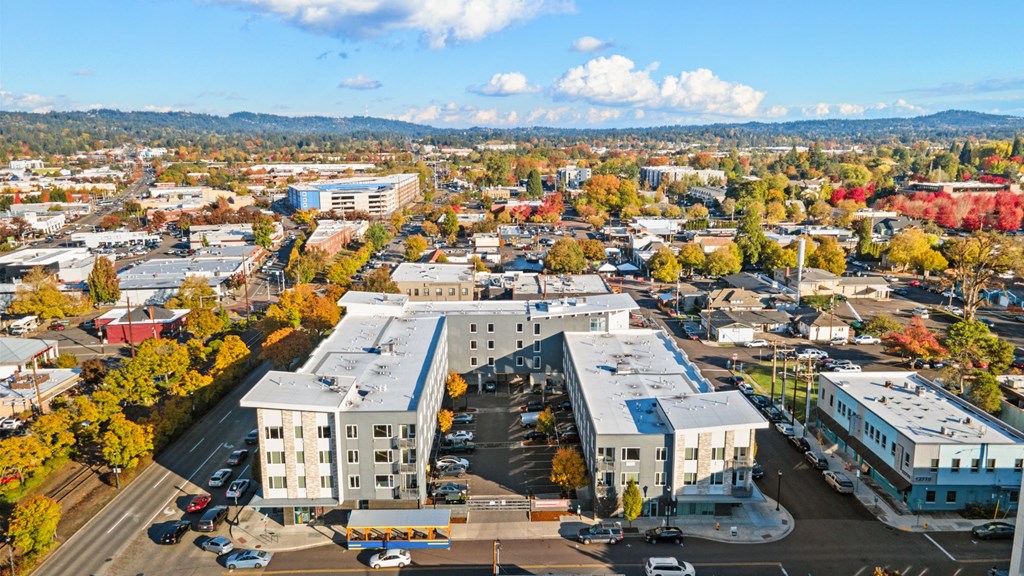 A large building with a parking lot in front of it.