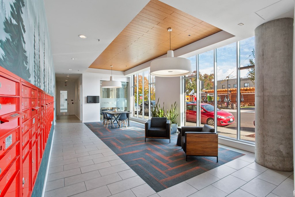 A modern interior with a red wall on the left and a wooden ceiling.