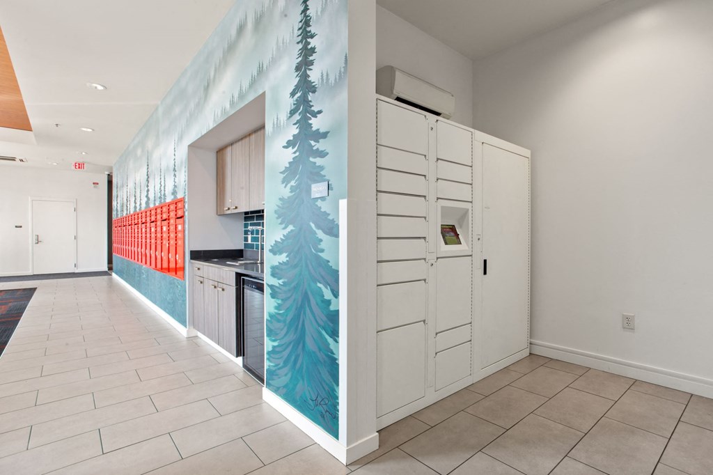 A hallway with a mural of trees on the wall.