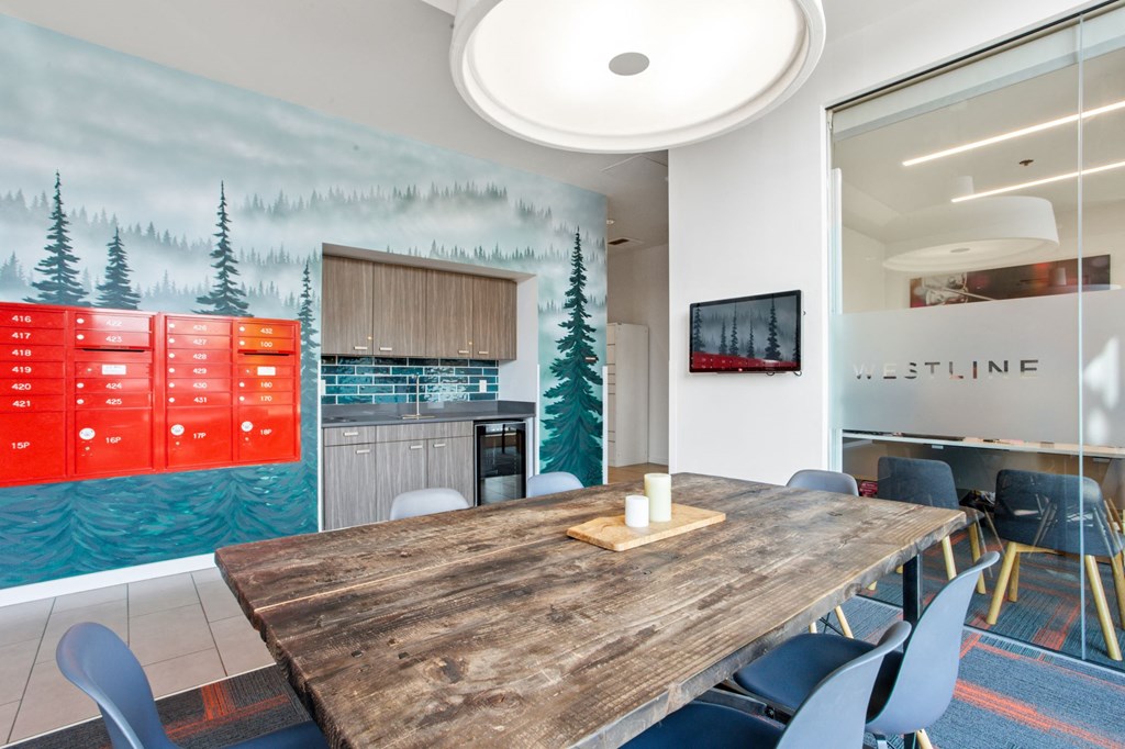 A conference room with a wooden table and chairs, a wall mural, and a glass wall with the word "WESTLINE" on it.