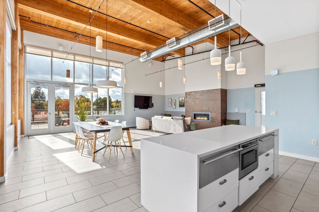 A modern kitchen with a dining table and chairs.