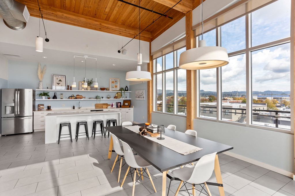 A modern kitchen with a dining table and chairs.