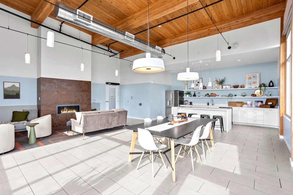 A modern open plan living and kitchen area with a dining table and chairs.