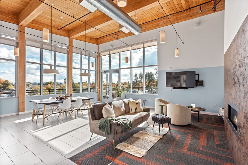 A living room with a couch, chairs, and a television.