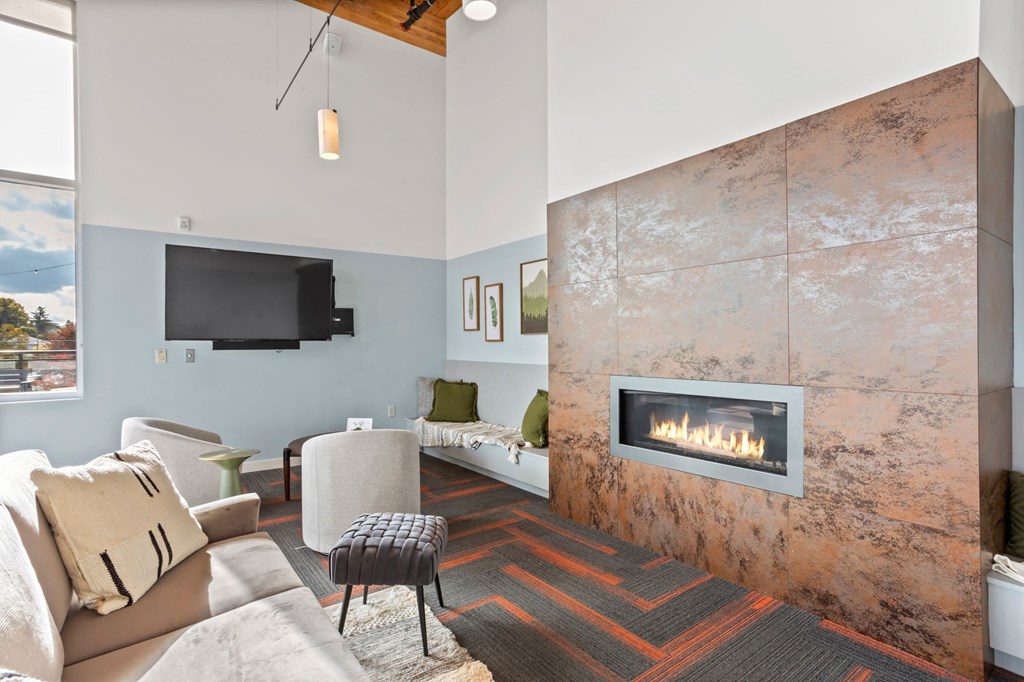 A living room with a fireplace and a television.