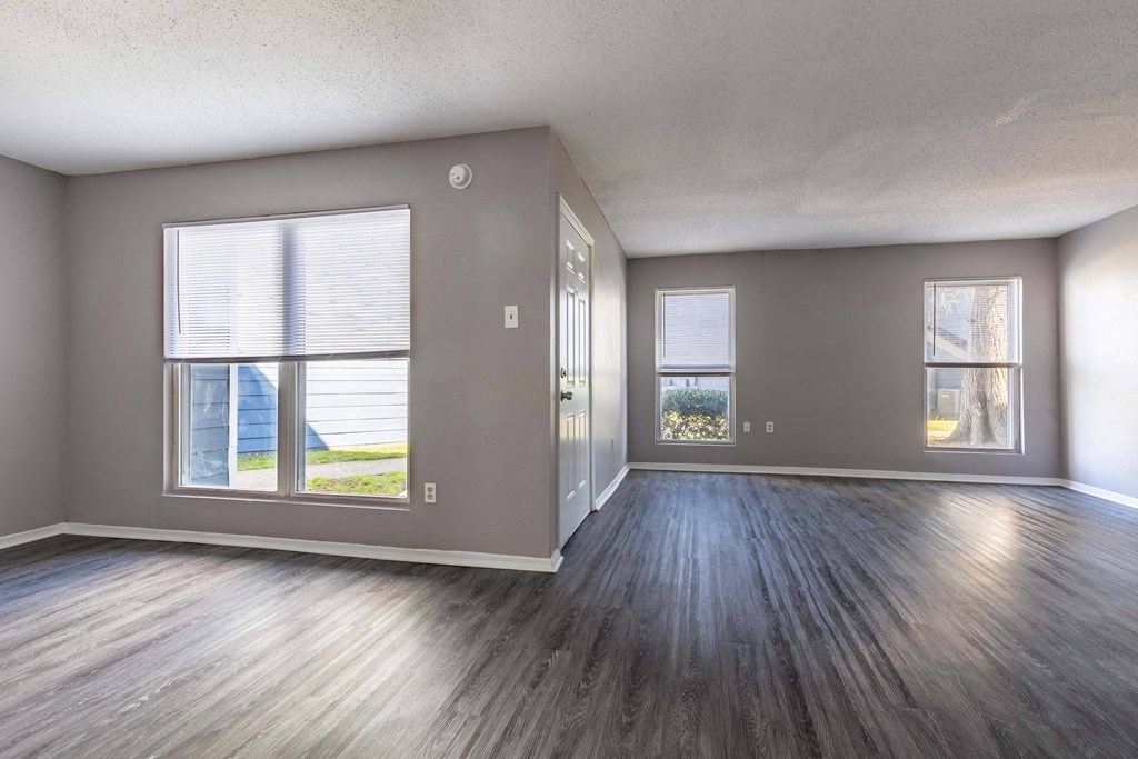 Whitney Manor Apartments in Gretna, LA photo of  an empty living room with wood floors and a window