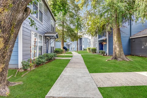 Whitney Manor Apartments in Gretna, LA photo of community buildings with greenery in between