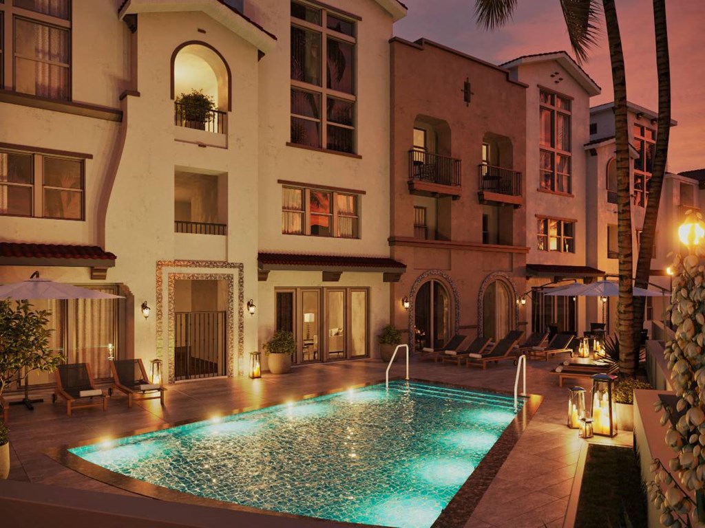 Whitter, CA Apartments - Cierra - Pool With Underwater Lights, Lounge Chairs, And Umbrellas