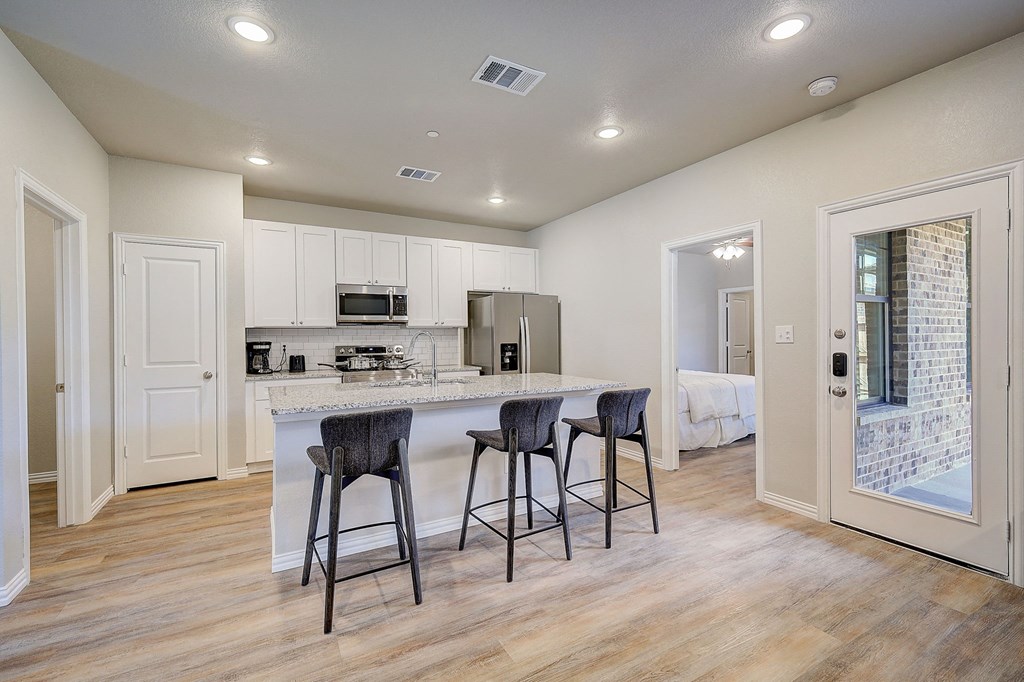 3 BR Townhomes in Willow Park TX - Willow Crossing - An interior shot of the kitchen, featuring an island and three bar stools