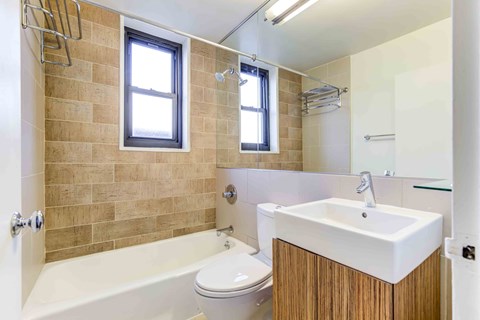 a bathroom with a sink toilet and a bath tub