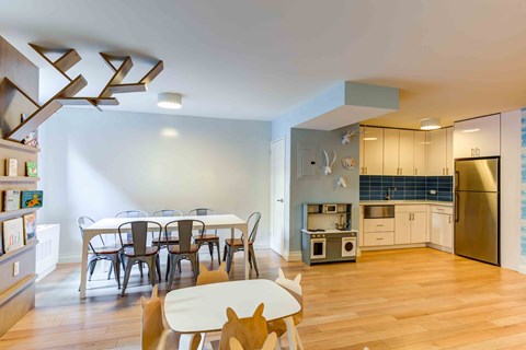 a kitchen and dining room with a table and chairs