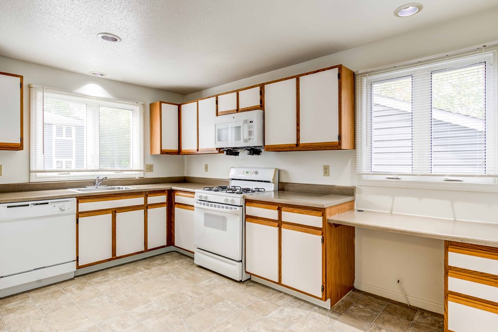 large kitchen with white appliances
