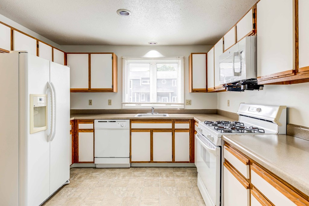 large kitchen with white appliances
