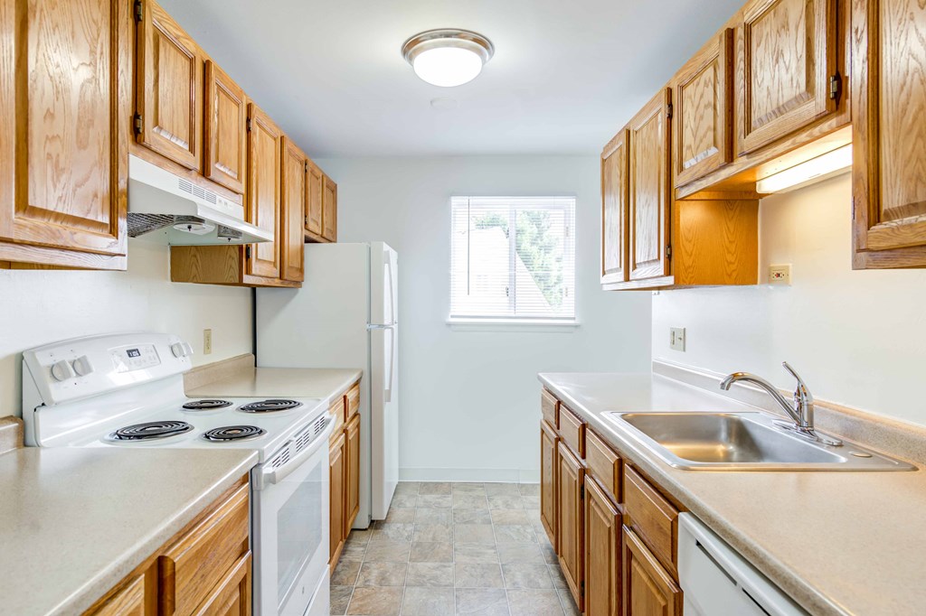 galley style kitchen with white appliances