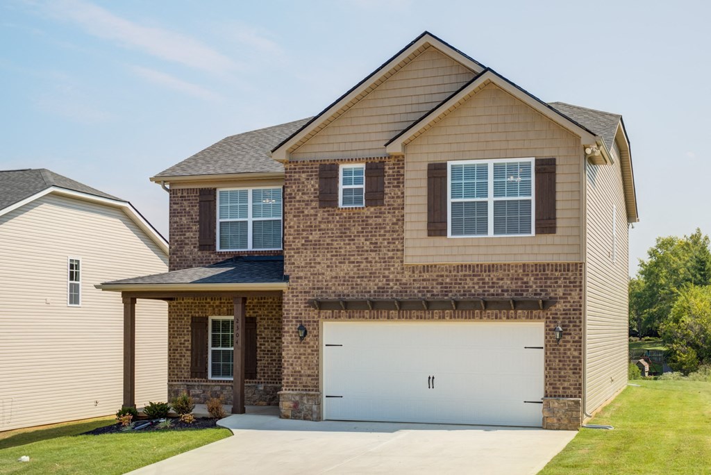 a house with a white garage door in front of it
