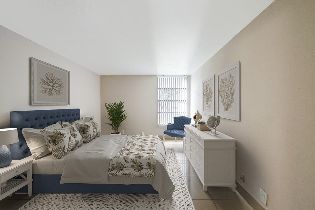 Windward vista apartments in Lauderhill, FL photo of a bedroom with a bed and a dresser and a window