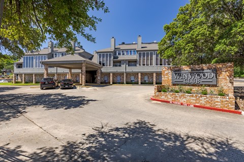 A Winwood sign is in front of a building.