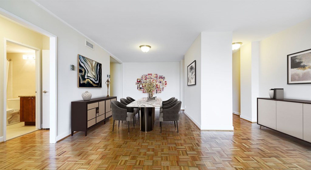 A dining room with a table set for four.