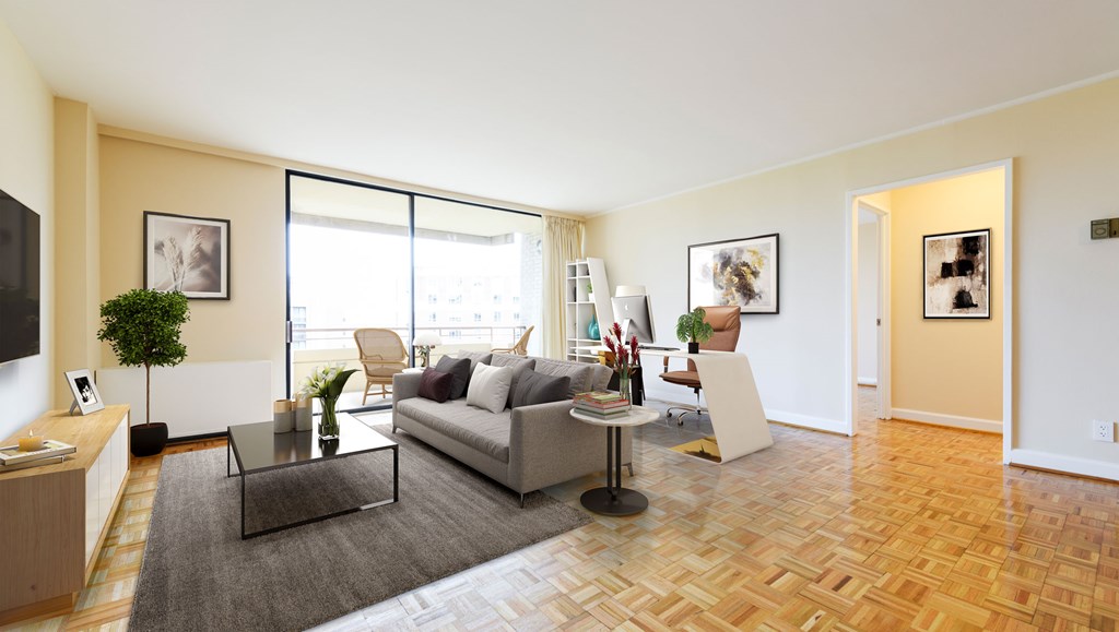A living room with a grey sofa and a glass coffee table.