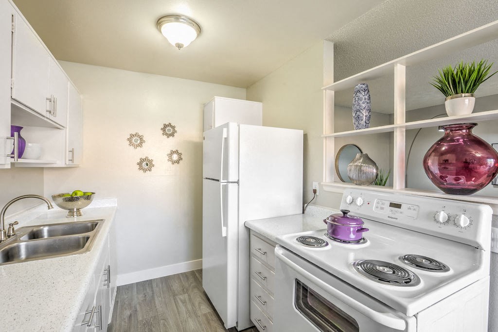 a white stove top oven sitting next to a white refrigerator