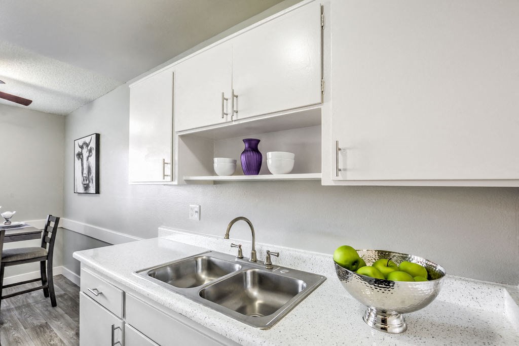 a kitchen with white cabinets and a sink