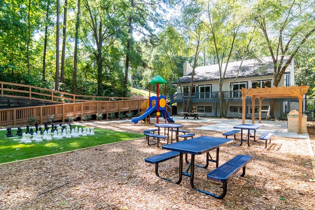 Picnic spaces with tables and green surroundings at Wyndcliff Galleria apartment community in Smyrna GA