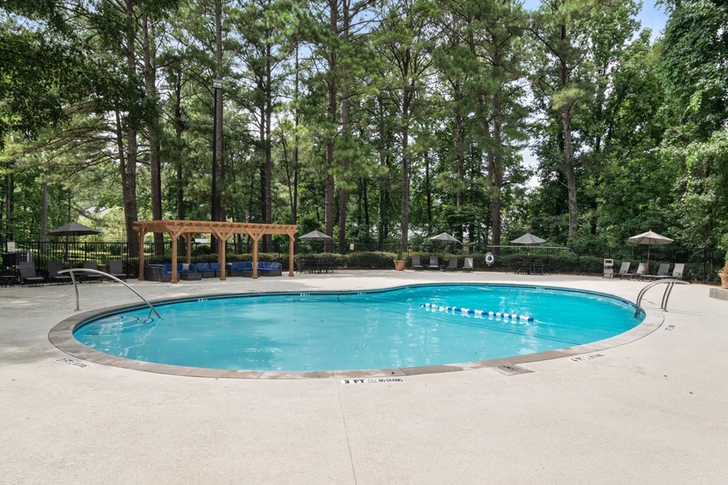 Resort-style swimming pool with lounge seating at Wyndcliff Galleria apartment community in Smyrna GA